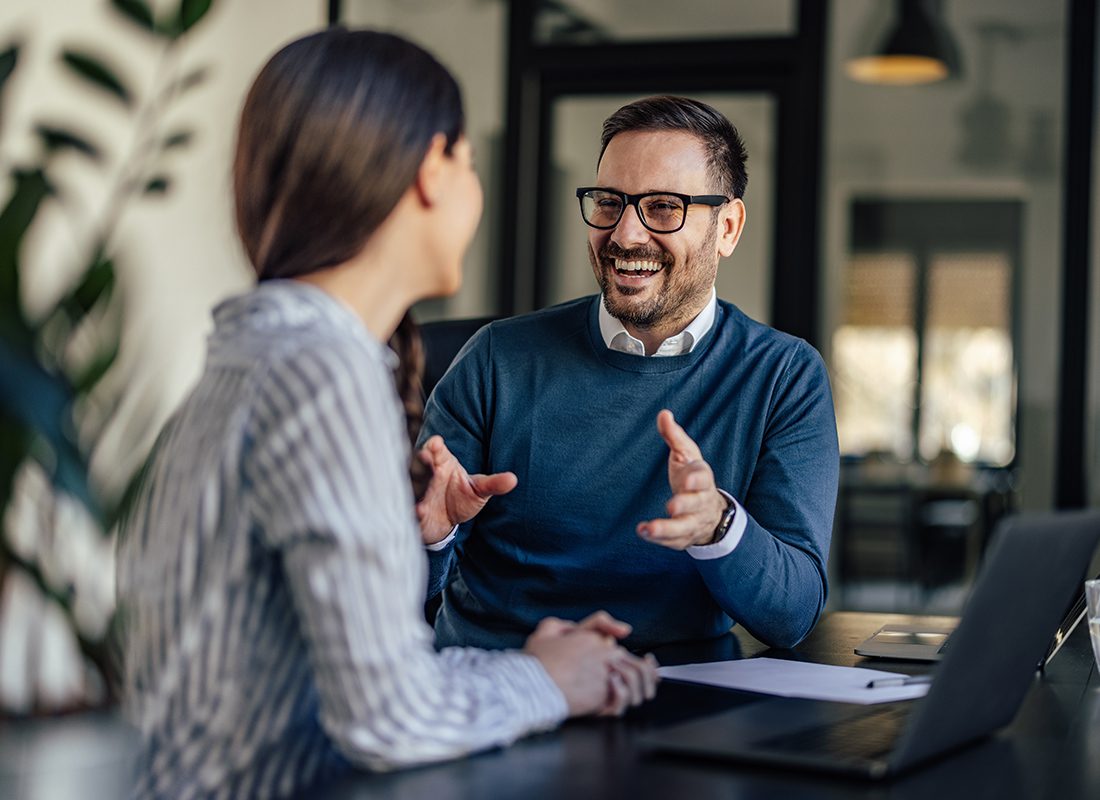 About Our Agency - Excited Business Man Speaking With a Colleague at an Office