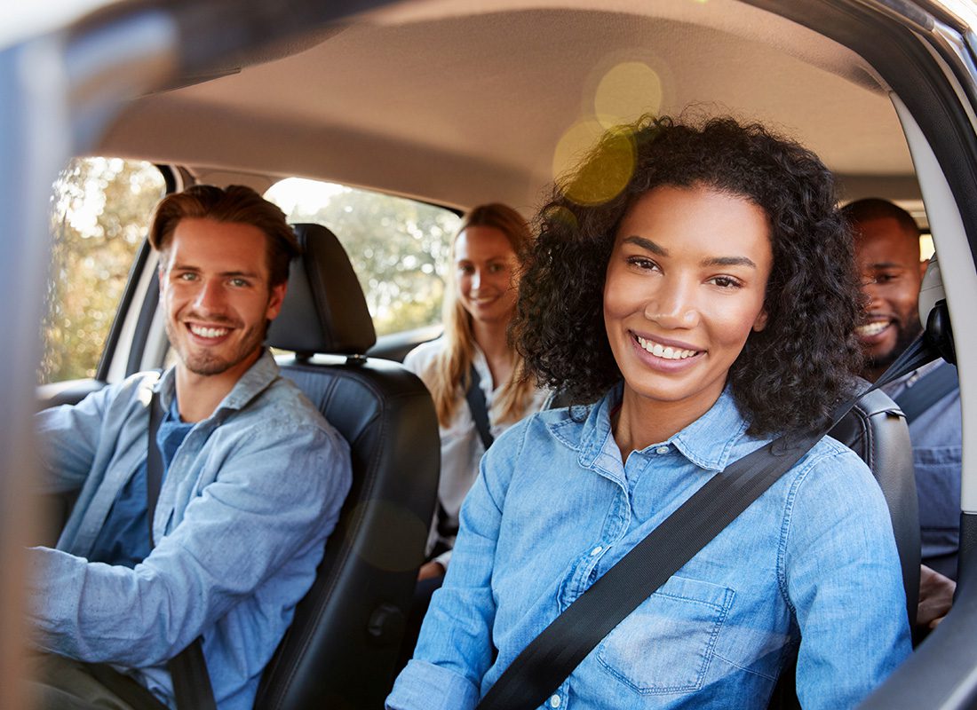 Personal Insurance - Group of Friendly Adults Sitting in a Car on a Sunny Day